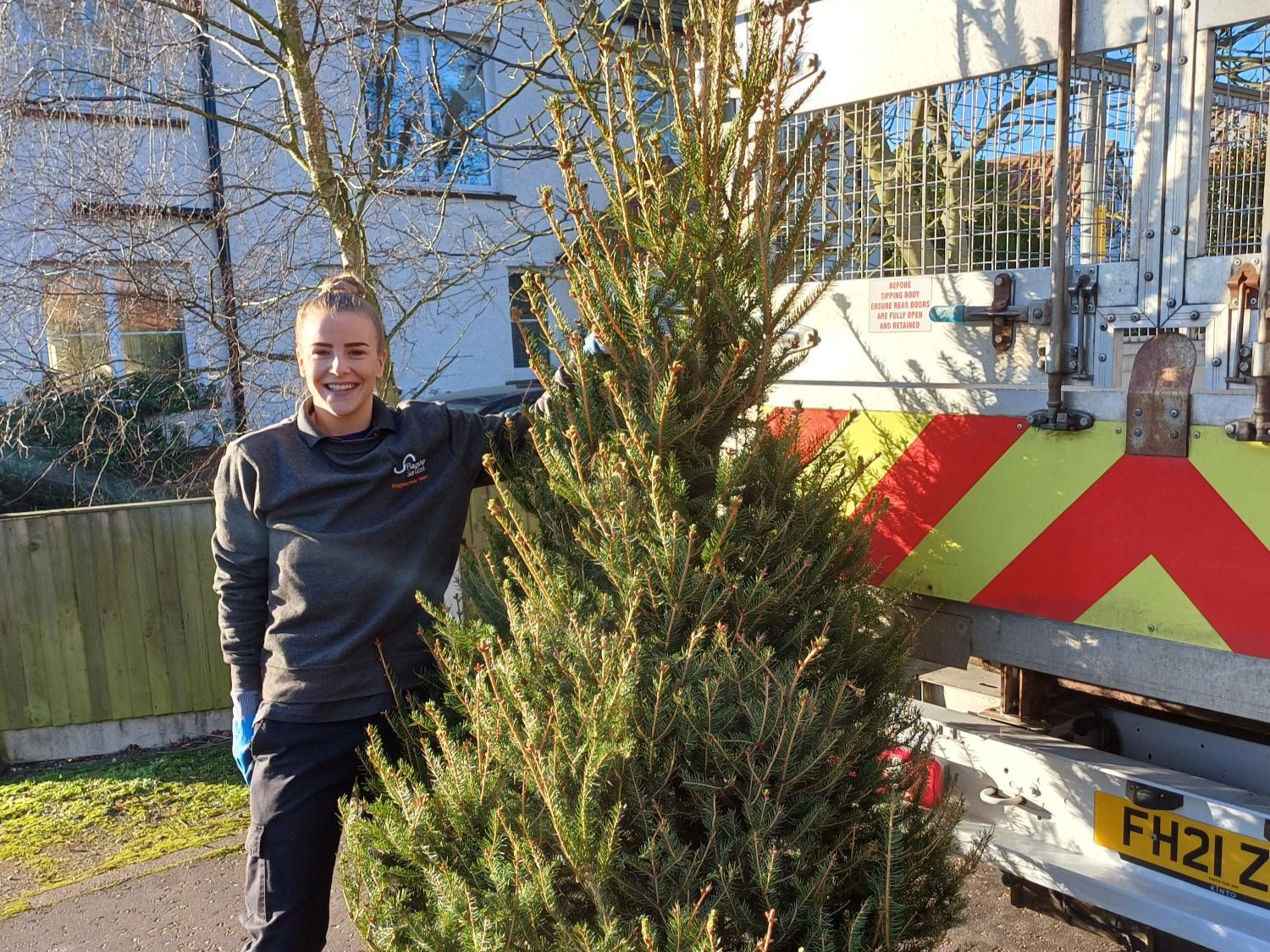 4. Neighbourhood Services Manager Charlotte Bane by a Flagship Services van with one of the collected Christmas trees