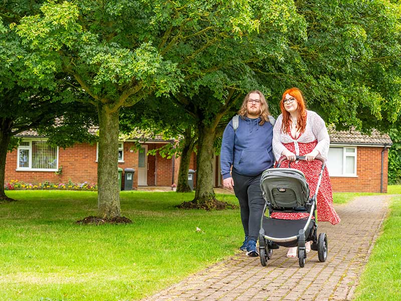 couple walking with pram