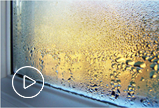 Image of window with condensation with play button overlaying