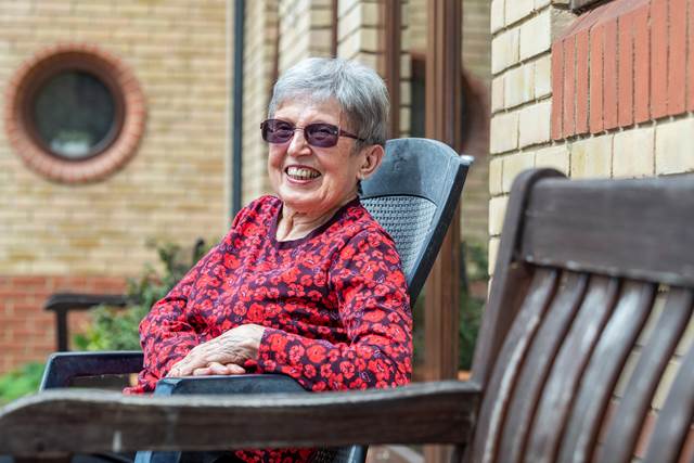 Elderly person sat on garden chair