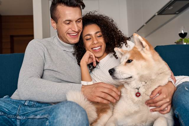 Couple on a sofa with their dog