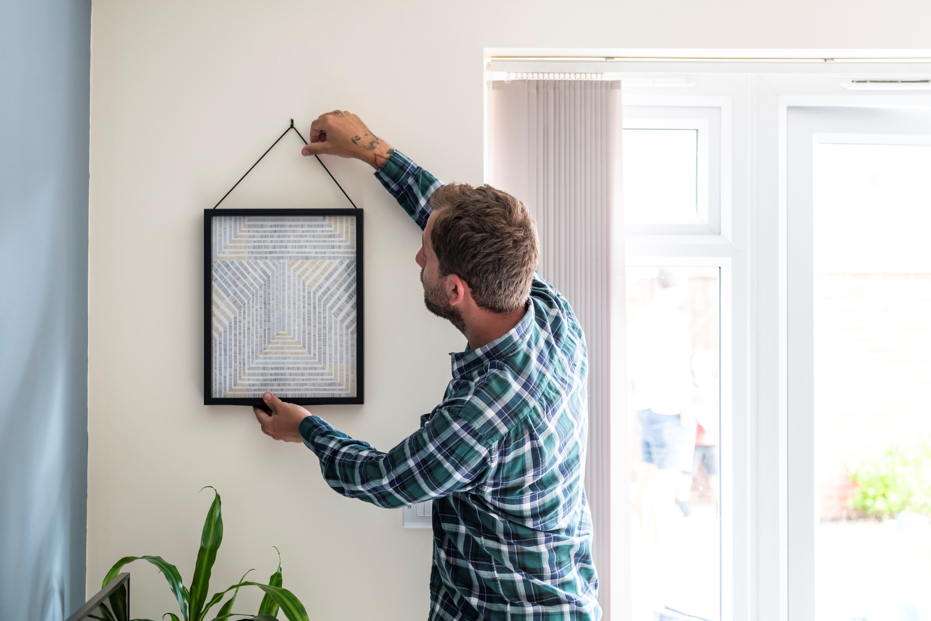 Man hanging a picture