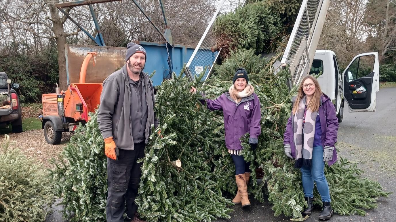 Flagship neighbourhood officer Jason Ding with EACH’s Laura Southcott (centre) and Katie Ingham (right) at EACH’s Norfolk site, where collected trees were chipped to be given to local farms