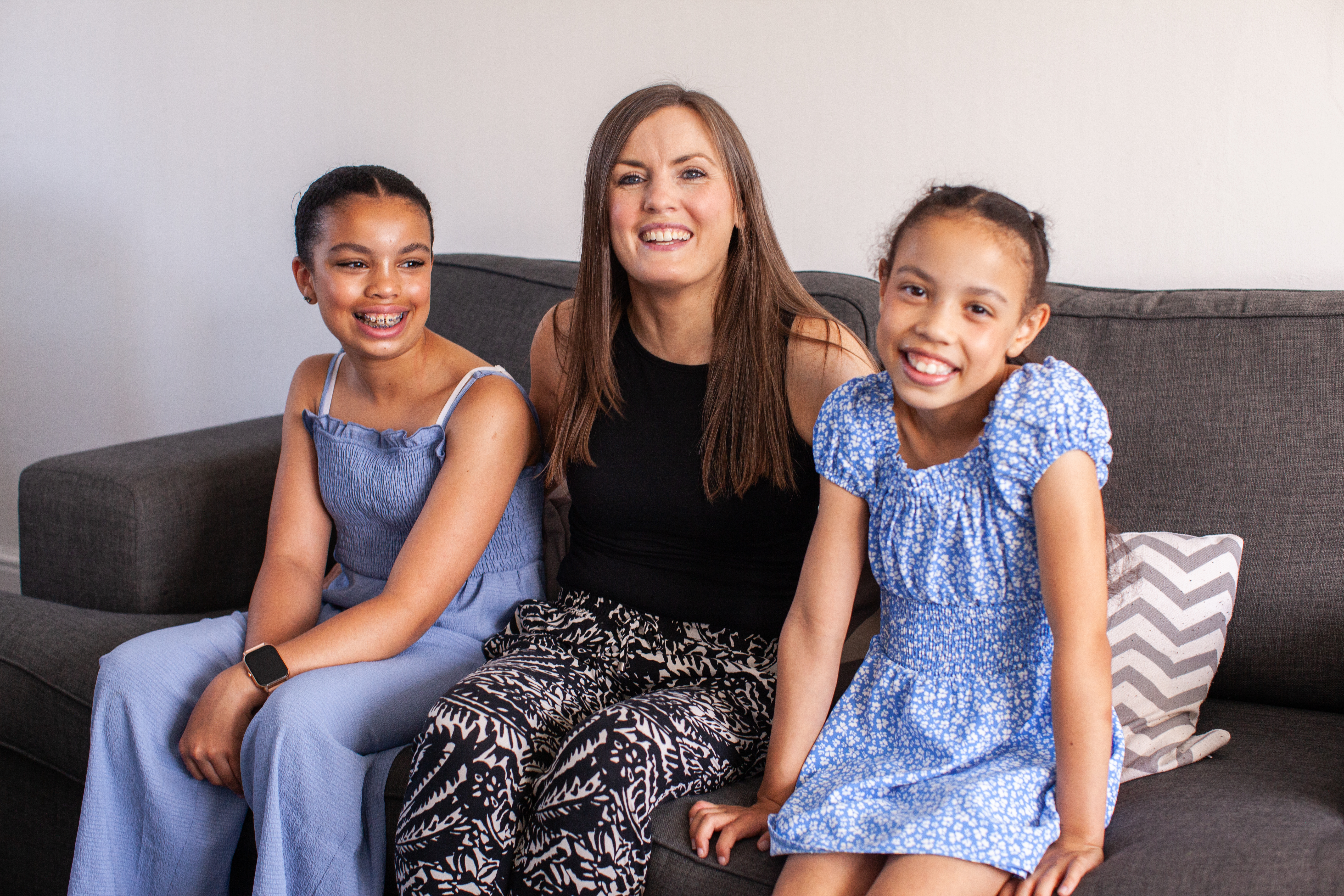 A mum and her two daughters on the sofa