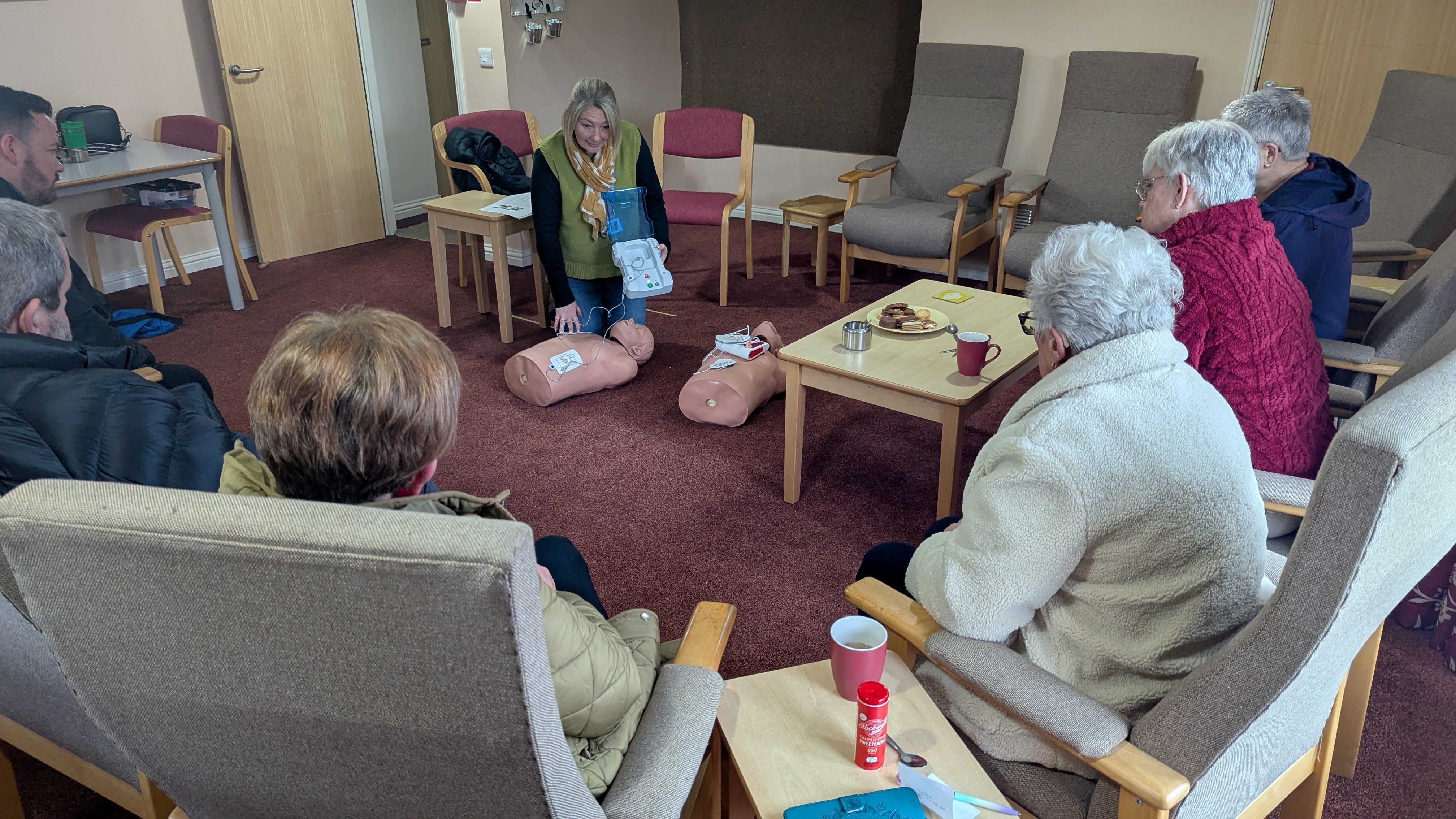 Residents watch on as Flagship training manager Lyn Halsted delivers a first-aid training session