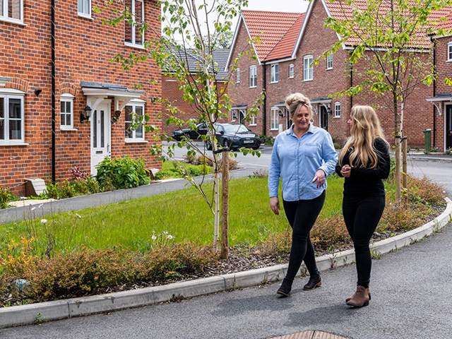 Two people walking through estate